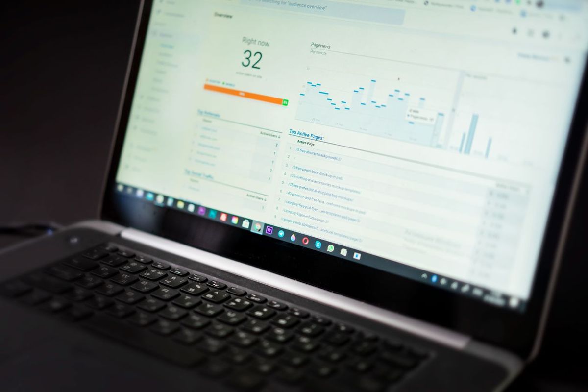 Laptop displaying a Google Analytics dashboard with traffic charts