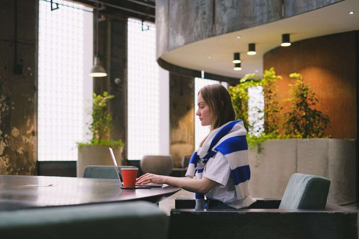 Woman working on her laptop in a modern office, building a website